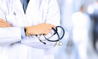 Portrait of a doctor standing in a hospital holding a stethoscope