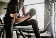 Man working out with a dumbbell in a gym