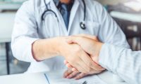 Doctor and patient shaking hands at a consultation